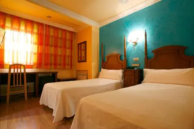 Cama o camas de una habitación en Hostal Victoria II