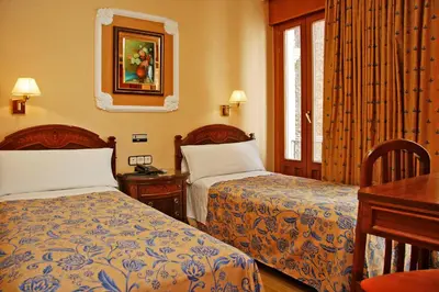 Cama o camas de una habitación en Hostal Victoria III