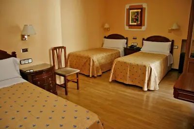 Cama o camas de una habitación en Hostal Victoria III