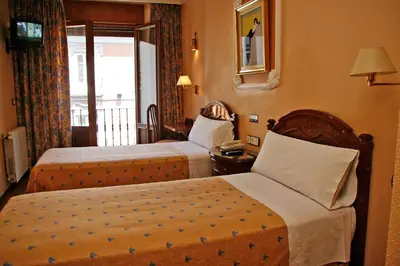 Cama o camas de una habitación en Hostal Victoria III