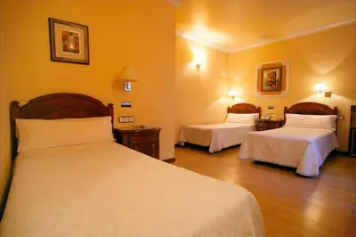 Cama o camas de una habitación en Hostal Victoria III