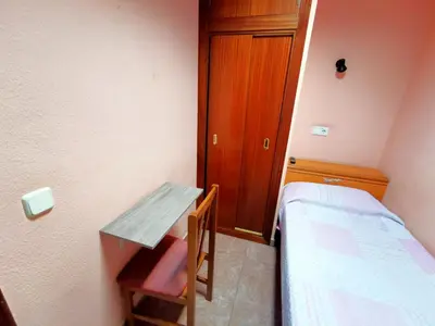 Cama o camas de una habitación en Casa de Huespedes La Asturiana
