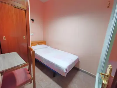 Cama o camas de una habitación en Casa de Huespedes La Asturiana
