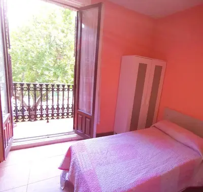Cama o camas de una habitación en Casa de Huespedes La Asturiana
