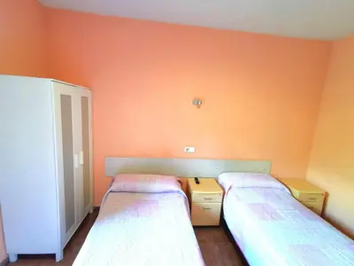 Cama o camas de una habitación en Casa de Huespedes La Asturiana