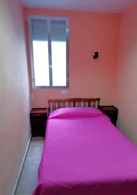Cama o camas de una habitación en Casa de Huespedes La Asturiana
