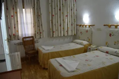Cama o camas de una habitación en Hostal Triana