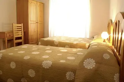 Cama o camas de una habitación en Hostal Las Torres