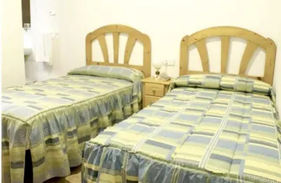 Cama o camas de una habitación en Hostal Las Torres