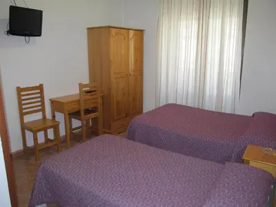 Cama o camas de una habitación en Hostal Las Torres