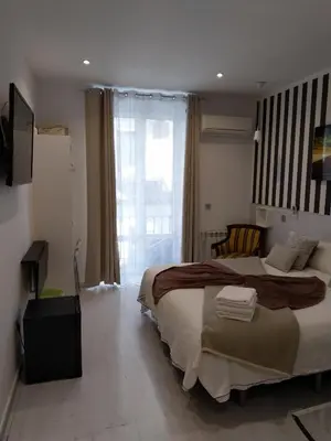Cama o camas de una habitación en Hostal Mendoza