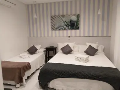 Cama o camas de una habitación en Hostal Mendoza