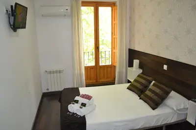 Cama o camas de una habitación en Hostal El Brezo