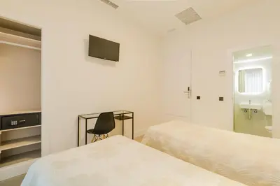 Cama o camas de una habitación en Hostal Excelsior