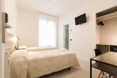 Cama o camas de una habitación en Hostal Excelsior