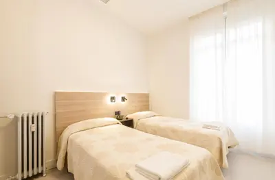 Cama o camas de una habitación en Hostal Excelsior
