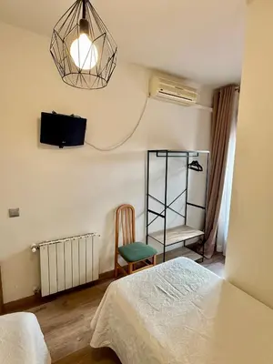 Cama o camas de una habitación en Hostal Fernández Atocha