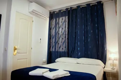 Cama o camas de una habitación en Hostal Ártico
