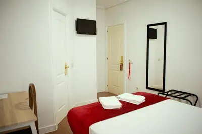 Cama o camas de una habitación en Hostal Ártico