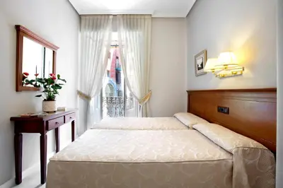 Cama o camas de una habitación en Hostal Macarena