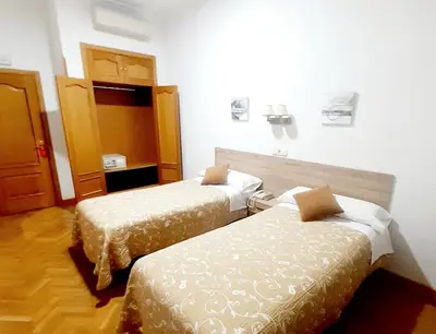 Cama o camas de una habitación en Hostal Biarritz