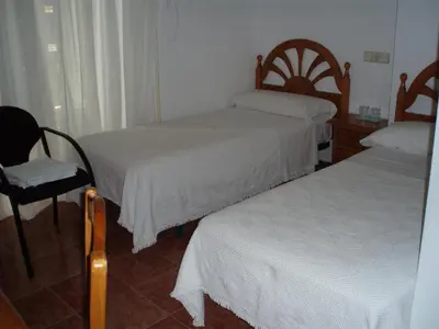 Cama o camas de una habitación en Hostal Castilla