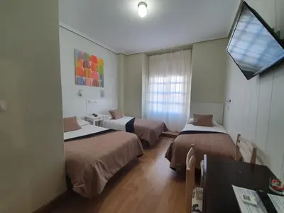 Cama o camas de una habitación en Hostal Riesco