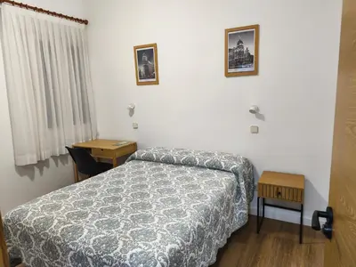 Cama o camas de una habitación en Hostal Angelines