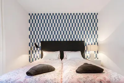 Cama o camas de una habitación en M&F MALASAÑA