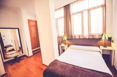 Cama o camas de una habitación en Hostal Sol Los Angeles