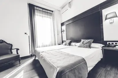 Cama o camas de una habitación en Hostal Sol Los Angeles