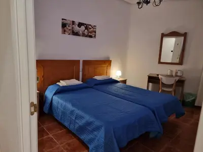 Cama o camas de una habitación en Casa de Huéspedes Cuenca