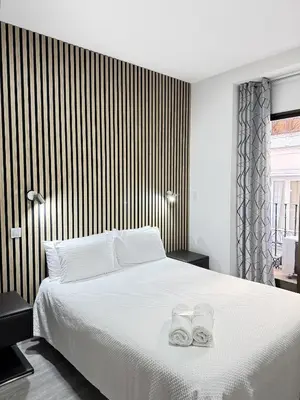 Cama o camas de una habitación en Apartamentos Day Madrid CALLAO I