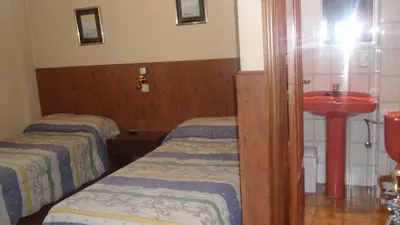 Cama o camas de una habitación en Hostal Suárez