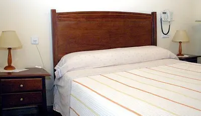 Cama o camas de una habitación en Hostal Delfina