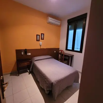 Cama o camas de una habitación en Hostal Pan America