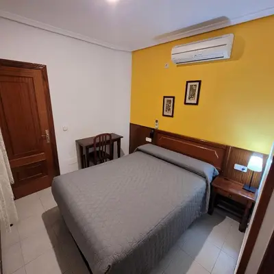 Cama o camas de una habitación en Hostal Pan America