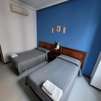 Cama o camas de una habitación en Hostal Pan America