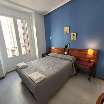 Cama o camas de una habitación en Hostal Pan America