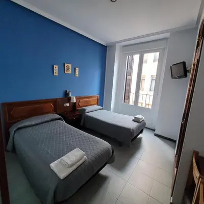 Cama o camas de una habitación en Hostal Pan America