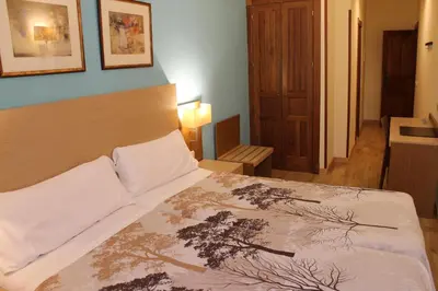 Cama o camas de una habitación en Hotel Mirador Puerta del Sol