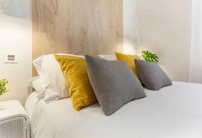 Cama o camas de una habitación en Iriarte en Madrid