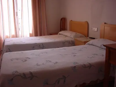 Cama o camas de una habitación en Hostal Casanova