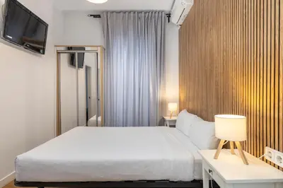 Cama o camas de una habitación en H-A San Mateo Suites