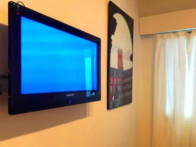 Una televisión o centro de entretenimiento en La Reina de Gran Via - PARKING TPH