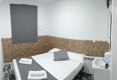 Cama o camas de una habitación en HOSTAL Noche y Dia