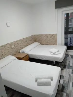 Cama o camas de una habitación en HOSTAL Noche y Dia