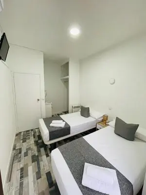 Cama o camas de una habitación en HOSTAL Noche y Dia