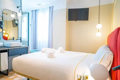 Cama o camas de una habitación en SmartRental Collection Gran Vía Capital
