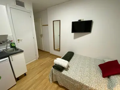 Una televisión o centro de entretenimiento en Apartamentos SmartRenting Justicia
